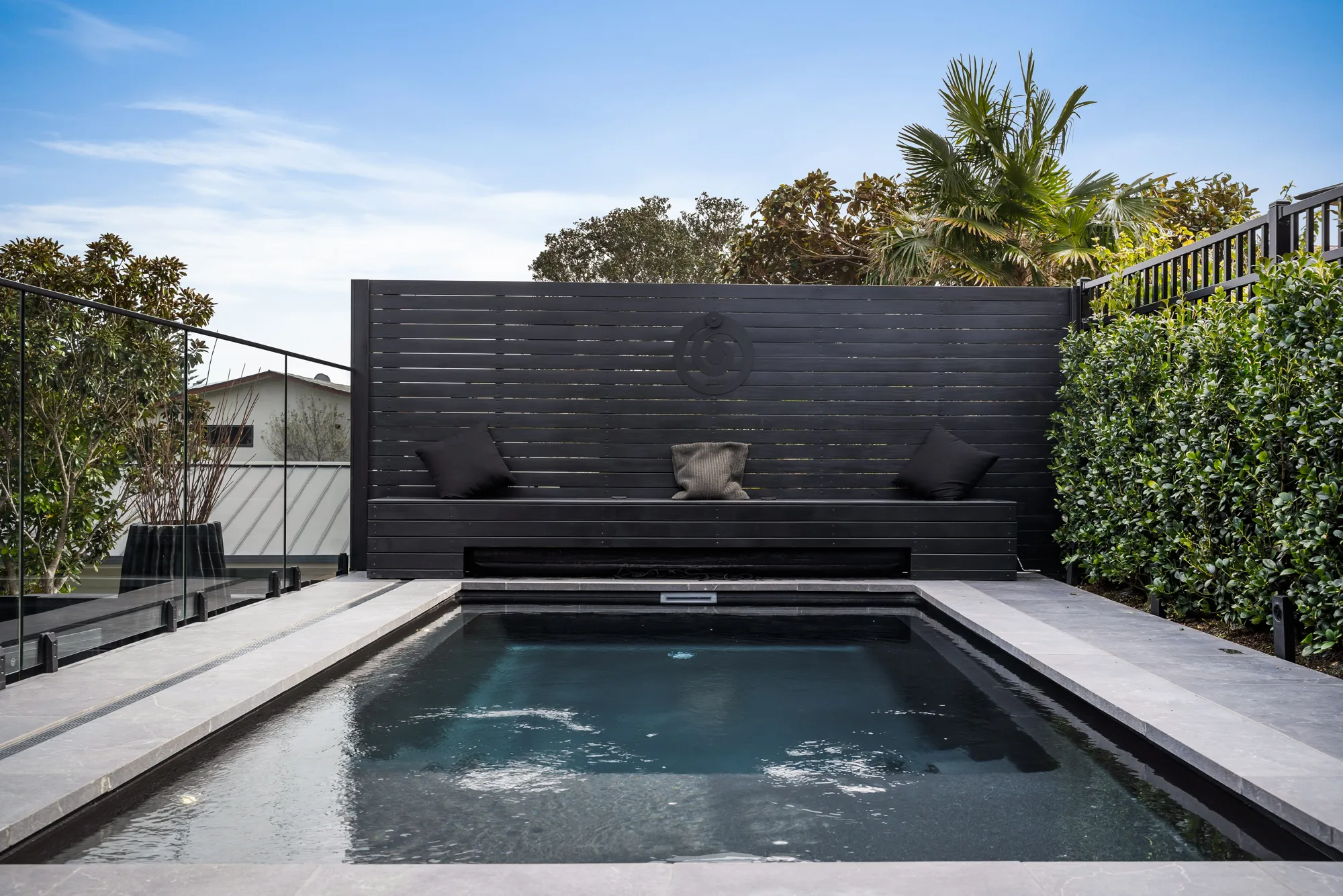Designer plunge pool with tiled surround in Auckland — tiling by Tarara Tiling, design by Kirsty Vegas