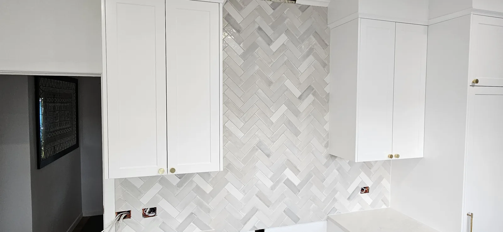 White herringbone splashback behind the hob, Auckland