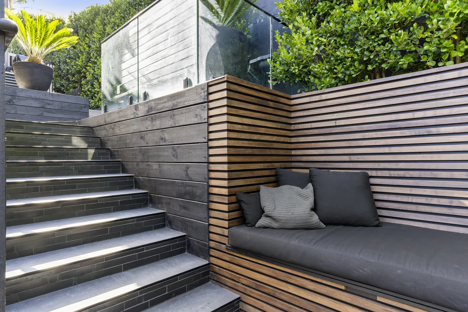 Tiled outdoor steps and courtyard living area in Auckland by Tarara Tiling