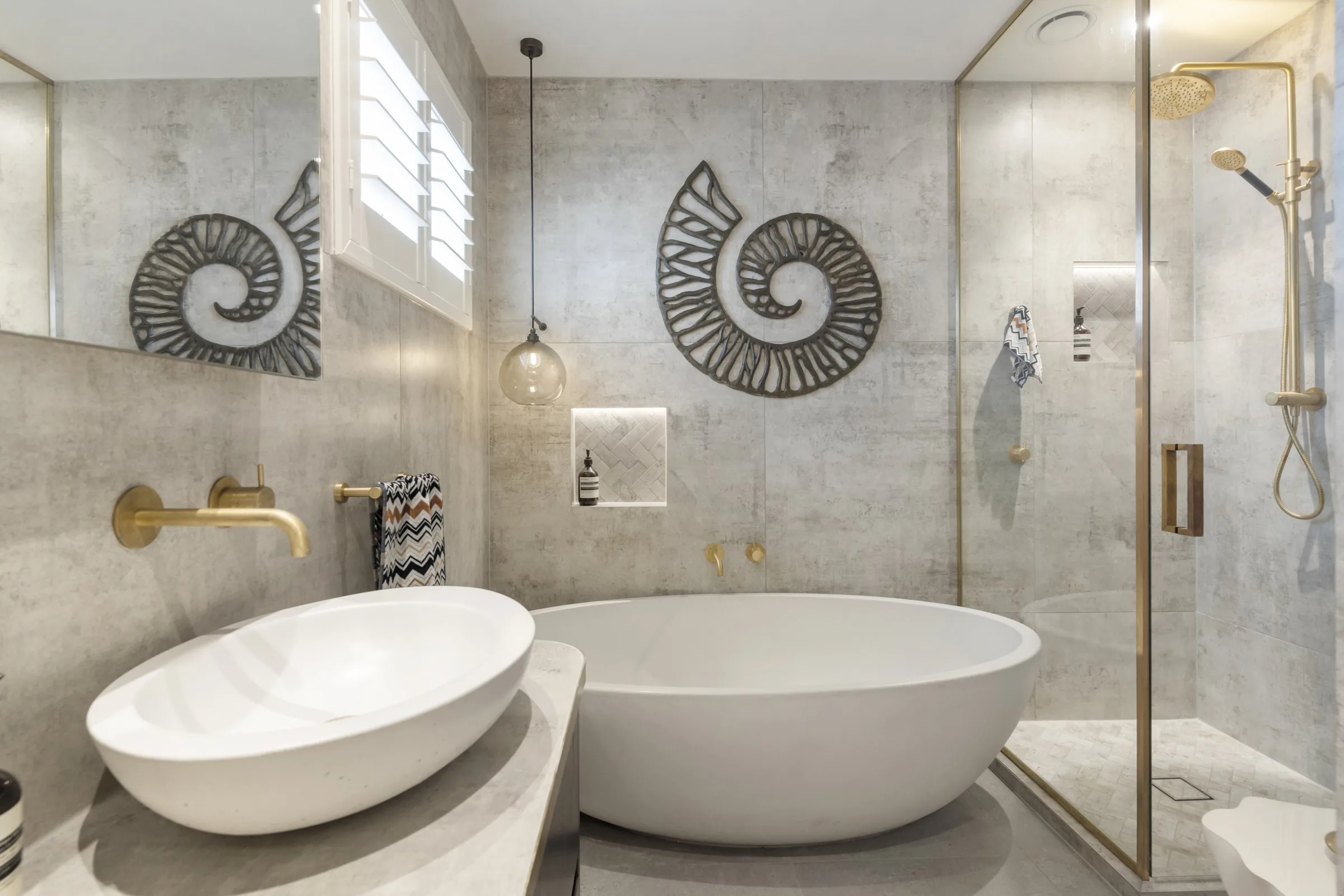 Croatian master tiler laying large-format porcelain in an Auckland bathroom