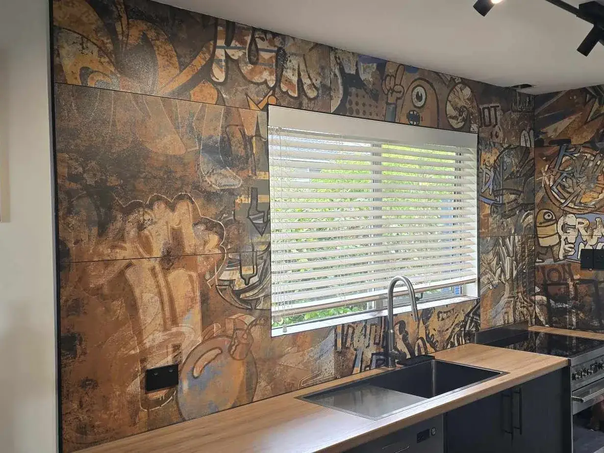 Vintage street-art print feature wall tiling in an Auckland kitchen by Tarara Tiling
